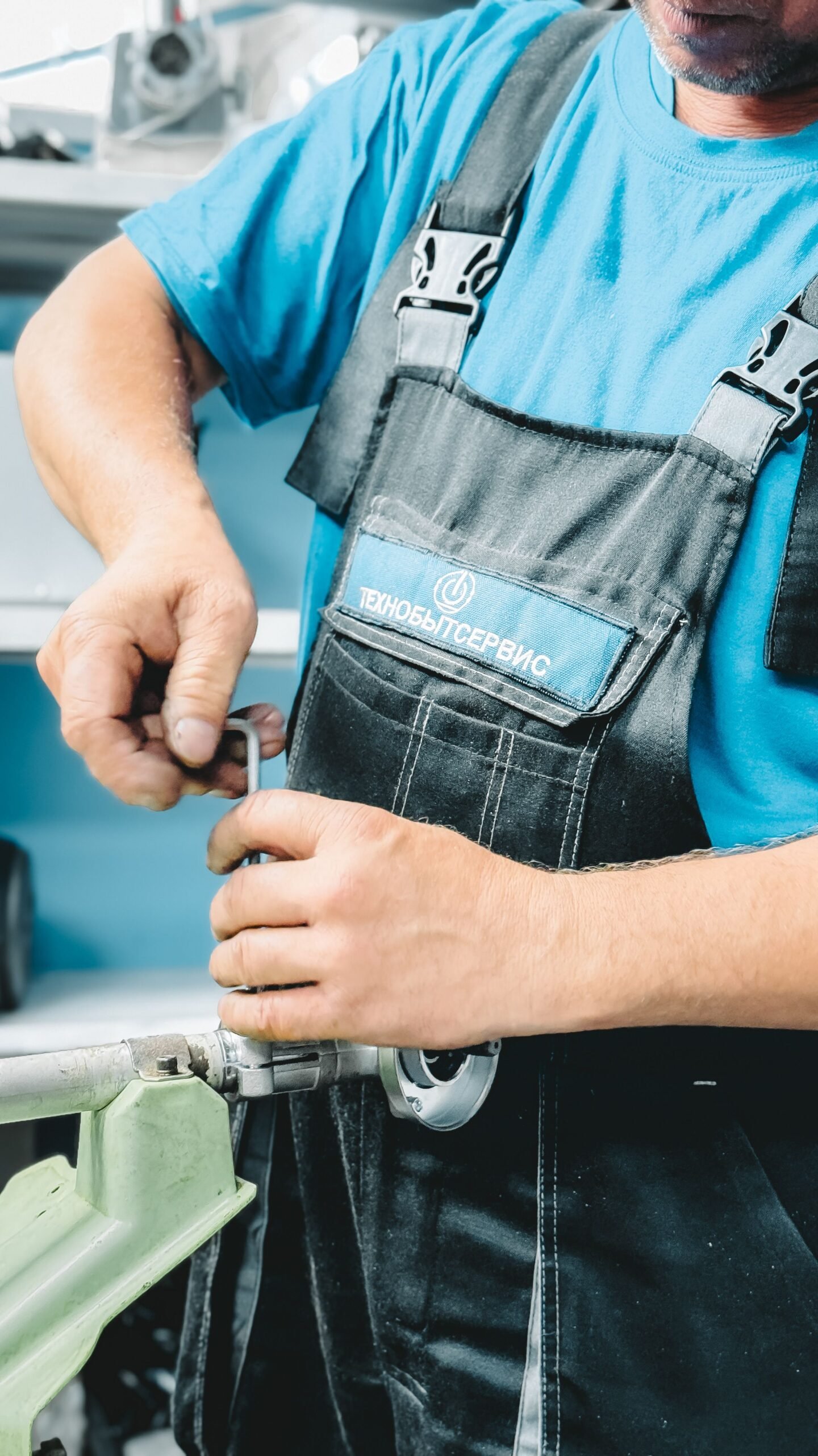 Professional plumber repairing a pipe fitting with a wrench
